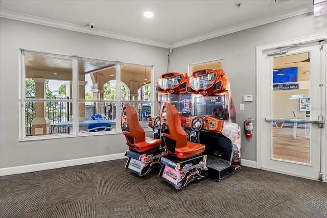 playroom with baseboards, dark colored carpet, and crown molding