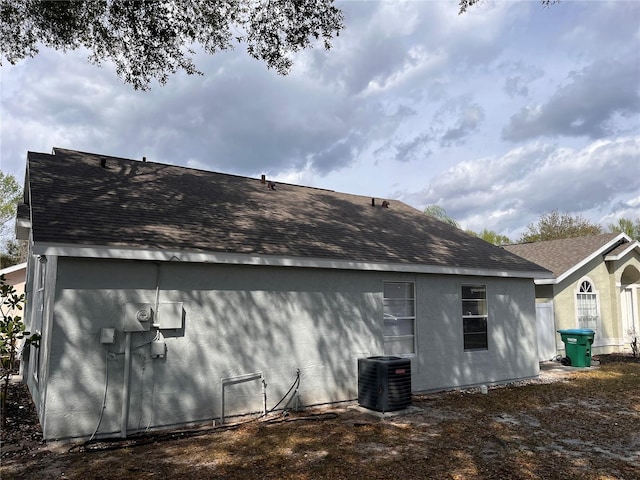 back of property featuring central air condition unit