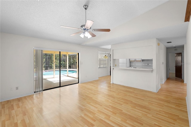 unfurnished living room with a textured ceiling, light hardwood / wood-style floors, and ceiling fan