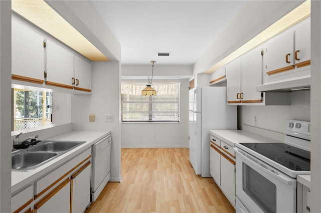 kitchen with pendant lighting, sink, white appliances, a wealth of natural light, and white cabinets