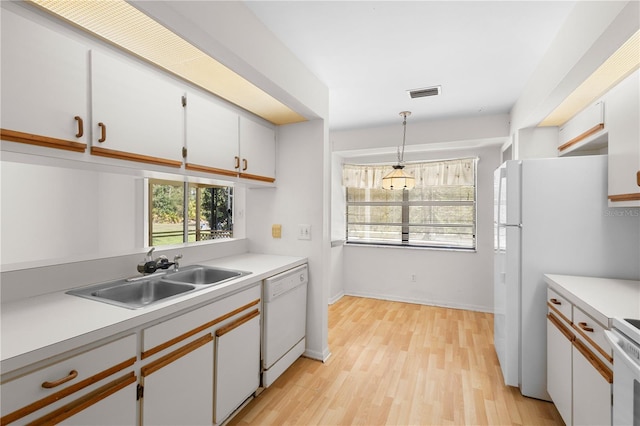 kitchen featuring white cabinetry, white appliances, and sink