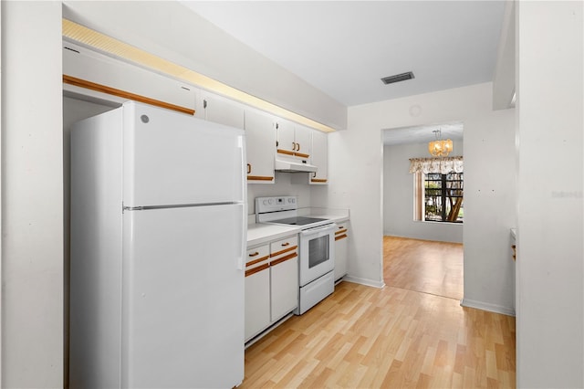 kitchen featuring white cabinetry, a notable chandelier, pendant lighting, white appliances, and light hardwood / wood-style floors