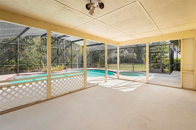 view of swimming pool featuring an in ground hot tub, a lanai, and a patio area