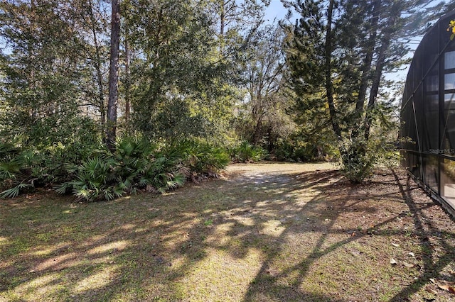 view of yard with glass enclosure