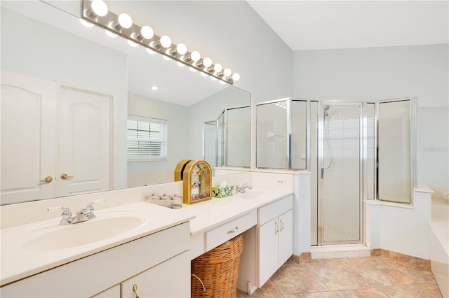 bathroom with a shower with door, vanity, and tile patterned flooring