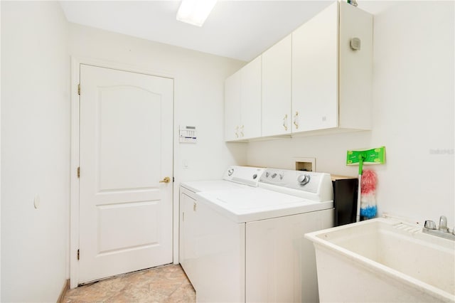 laundry room with washer and dryer, sink, and cabinets