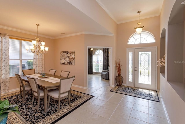 dining room with crown molding, light tile patterned floors, and a chandelier