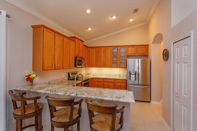 kitchen featuring light stone counters, ornamental molding, stainless steel appliances, and kitchen peninsula