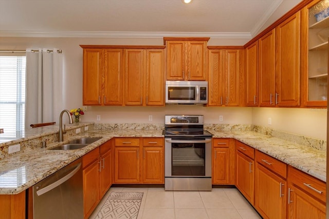 kitchen featuring sink, crown molding, stainless steel appliances, and light stone countertops