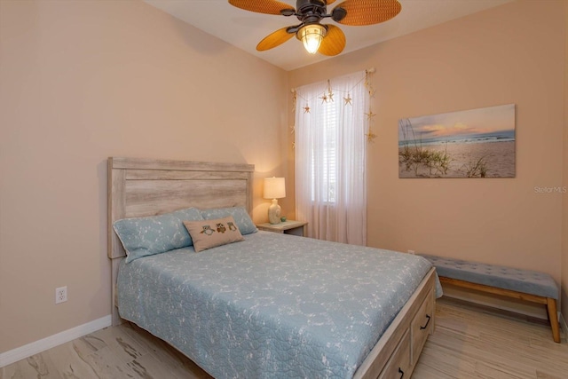 bedroom with ceiling fan and light hardwood / wood-style floors