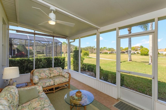 sunroom with ceiling fan and lofted ceiling