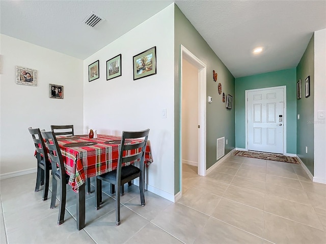 dining area featuring light tile patterned flooring