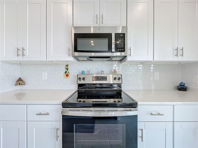 kitchen featuring white cabinetry, decorative backsplash, and stainless steel appliances