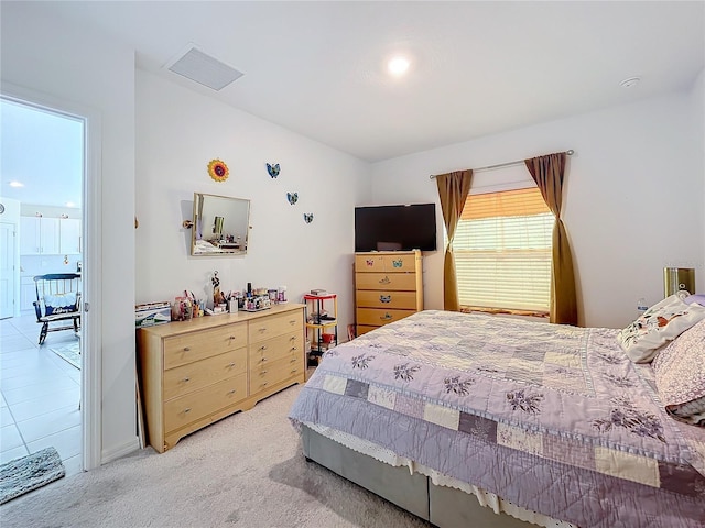 bedroom featuring light carpet