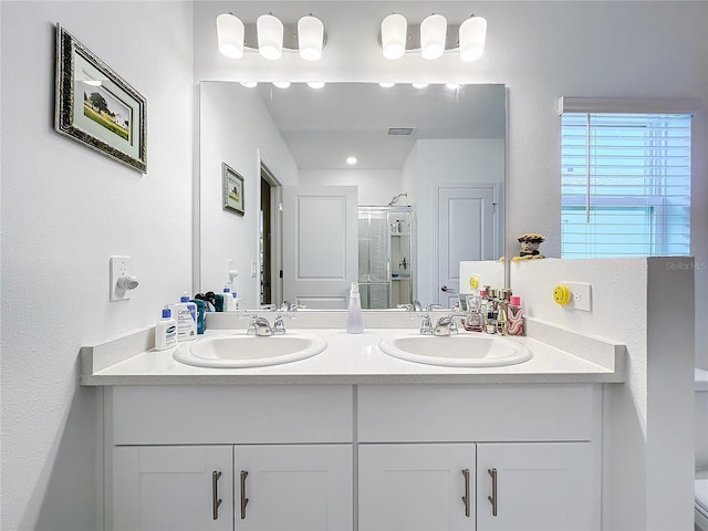 bathroom with an enclosed shower and vanity