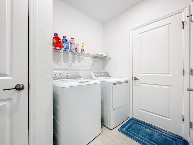 clothes washing area with separate washer and dryer