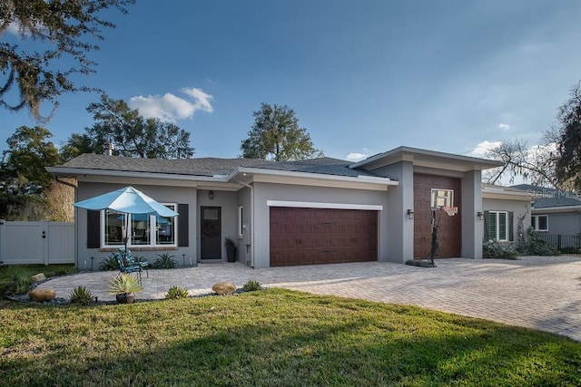 view of front of home featuring a garage and a front lawn