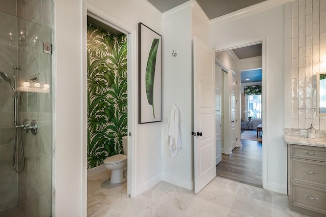 bathroom featuring vanity, crown molding, toilet, and tiled shower