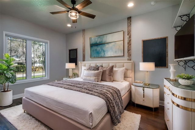 bedroom with ceiling fan and dark hardwood / wood-style flooring