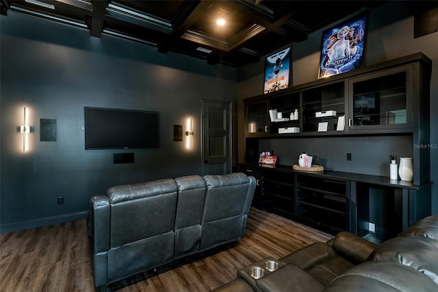 home theater featuring dark wood-type flooring, coffered ceiling, and beam ceiling