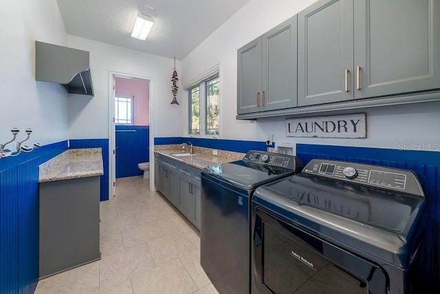 laundry area with cabinets, sink, independent washer and dryer, and a textured ceiling