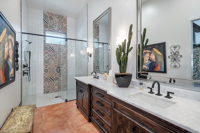 bathroom featuring vanity, a shower with shower door, and tile patterned floors