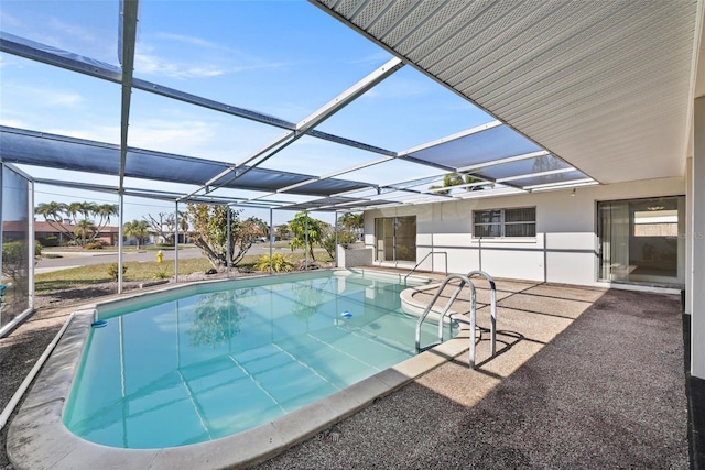 view of swimming pool with a patio area and glass enclosure