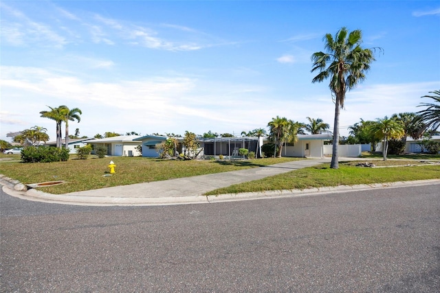 single story home featuring a front lawn