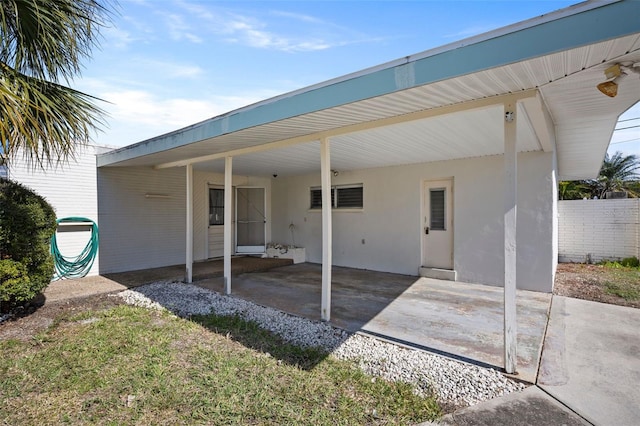 rear view of property featuring a carport