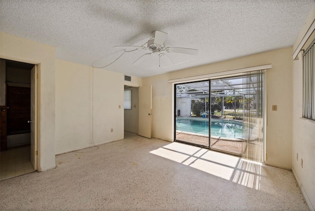 unfurnished room featuring ceiling fan and a textured ceiling