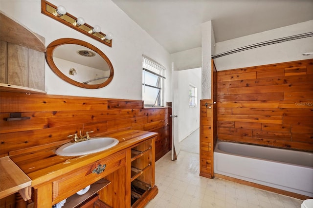 bathroom featuring vanity and wooden walls