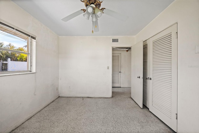 unfurnished bedroom featuring ceiling fan and a closet