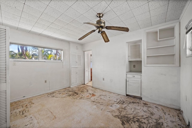 interior space with ceiling fan and light carpet