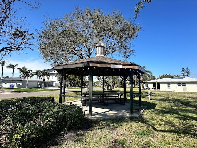 surrounding community with a gazebo and a lawn