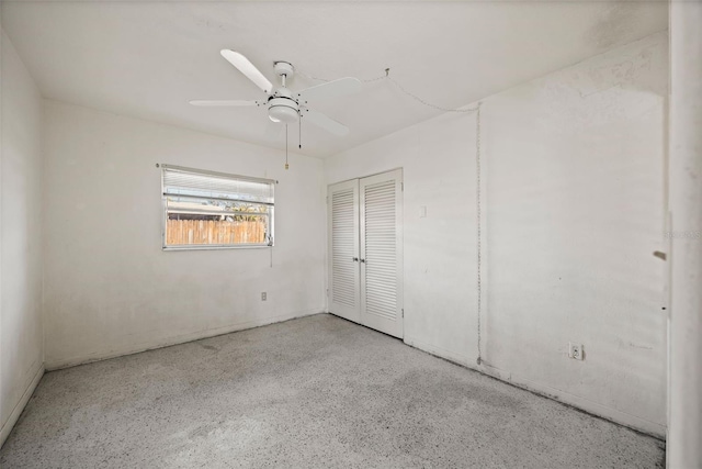 10111 Yacht Club Dr, Treasure Island, FL 33706 - unfurnished bedroom featuring speckled floor, a closet, and a ceiling fan