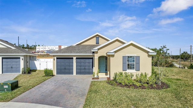 ranch-style home with a front yard, stucco siding, a garage, driveway, and a gate