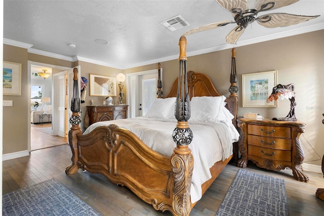 bedroom with multiple windows, ornamental molding, dark hardwood / wood-style flooring, and a textured ceiling