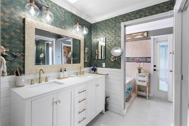 bathroom with ornamental molding, vanity, tile patterned floors, and a tub