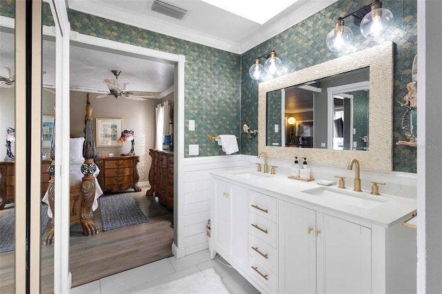 bathroom featuring crown molding, ceiling fan, vanity, and tile patterned flooring