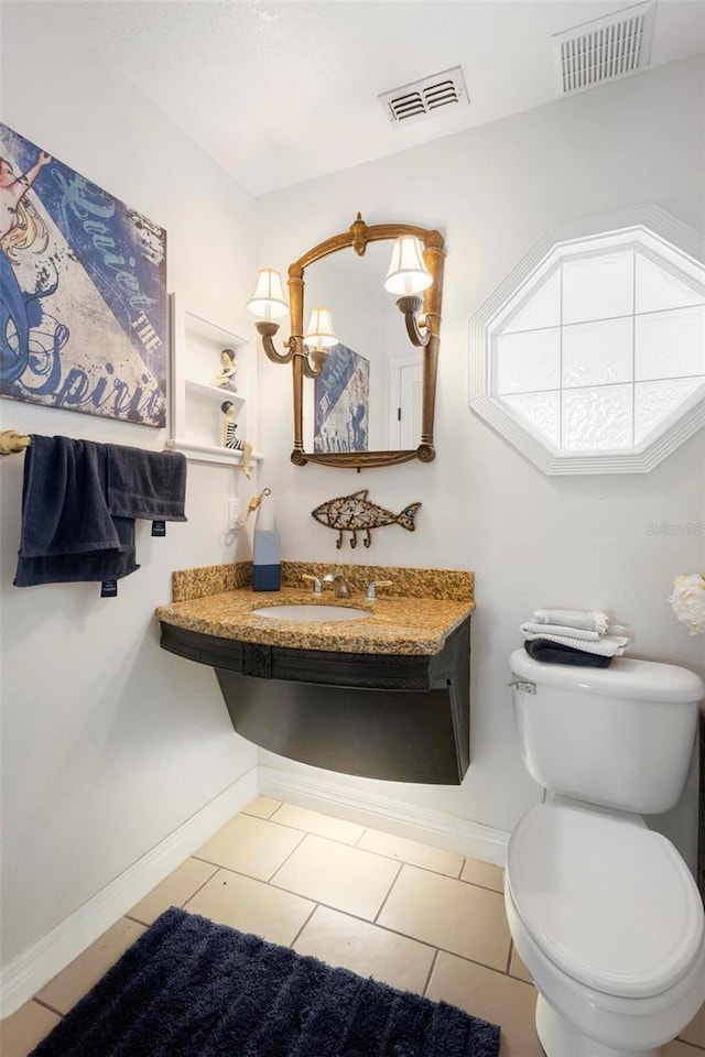 bathroom featuring tile patterned flooring, sink, and toilet