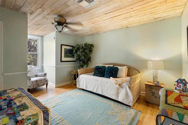 bedroom with ceiling fan, wooden ceiling, and light hardwood / wood-style floors