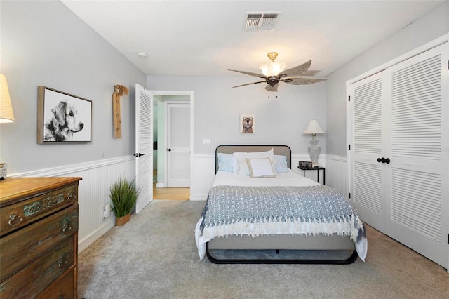 carpeted bedroom featuring a closet and ceiling fan