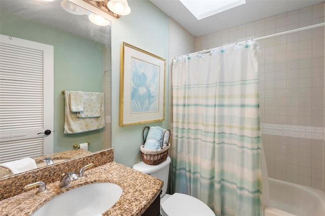 full bathroom featuring vanity, toilet, a skylight, and shower / bath combo with shower curtain