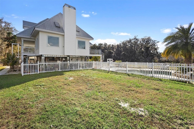 exterior space featuring a water view and a yard