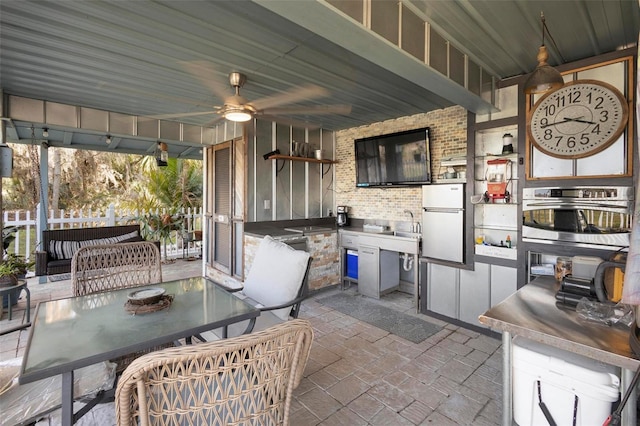 view of patio / terrace featuring ceiling fan and an outdoor kitchen