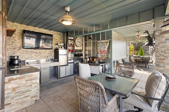 view of patio / terrace with exterior kitchen and ceiling fan