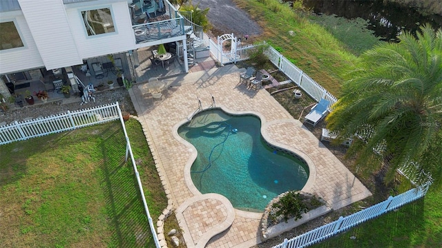 view of swimming pool featuring a yard and a patio