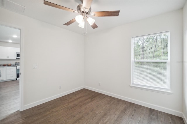 empty room featuring dark hardwood / wood-style flooring and ceiling fan