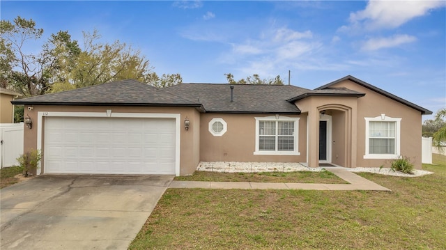 single story home with a garage, concrete driveway, a front lawn, and stucco siding