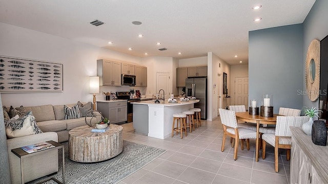 living room with sink and light tile patterned floors